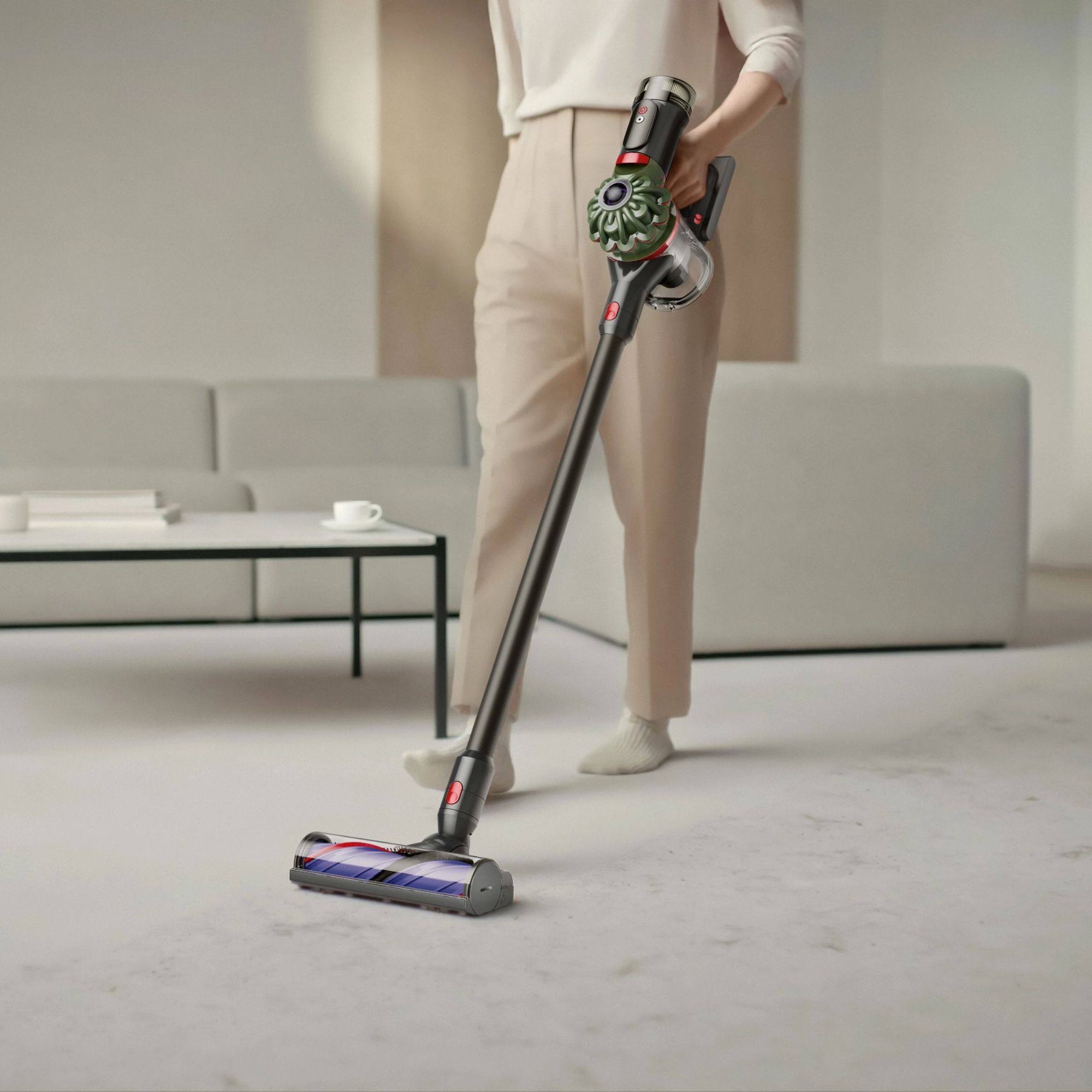 Person using Dyson V8 Cyclone on cream carpet