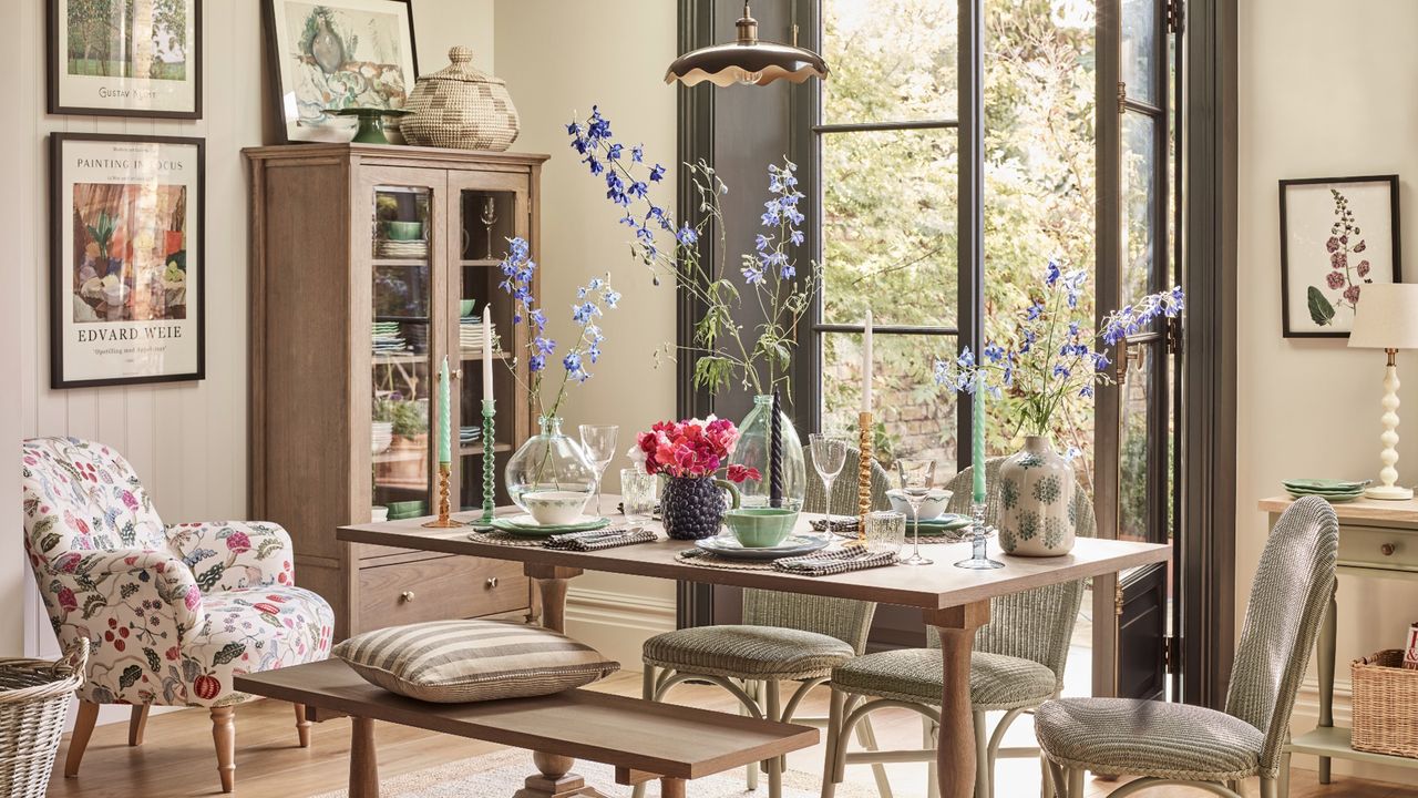 Dinner party spread with flowers in vases, candle holders, and floral patterns