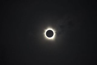 The total solar eclipse of November 13-14,2012. The clouds cleared in time for observers at Palm Cove, Australia, to experience totality as the Moon totally obscured the Sun for around two minutes, revealing the Sun's bright corona.
