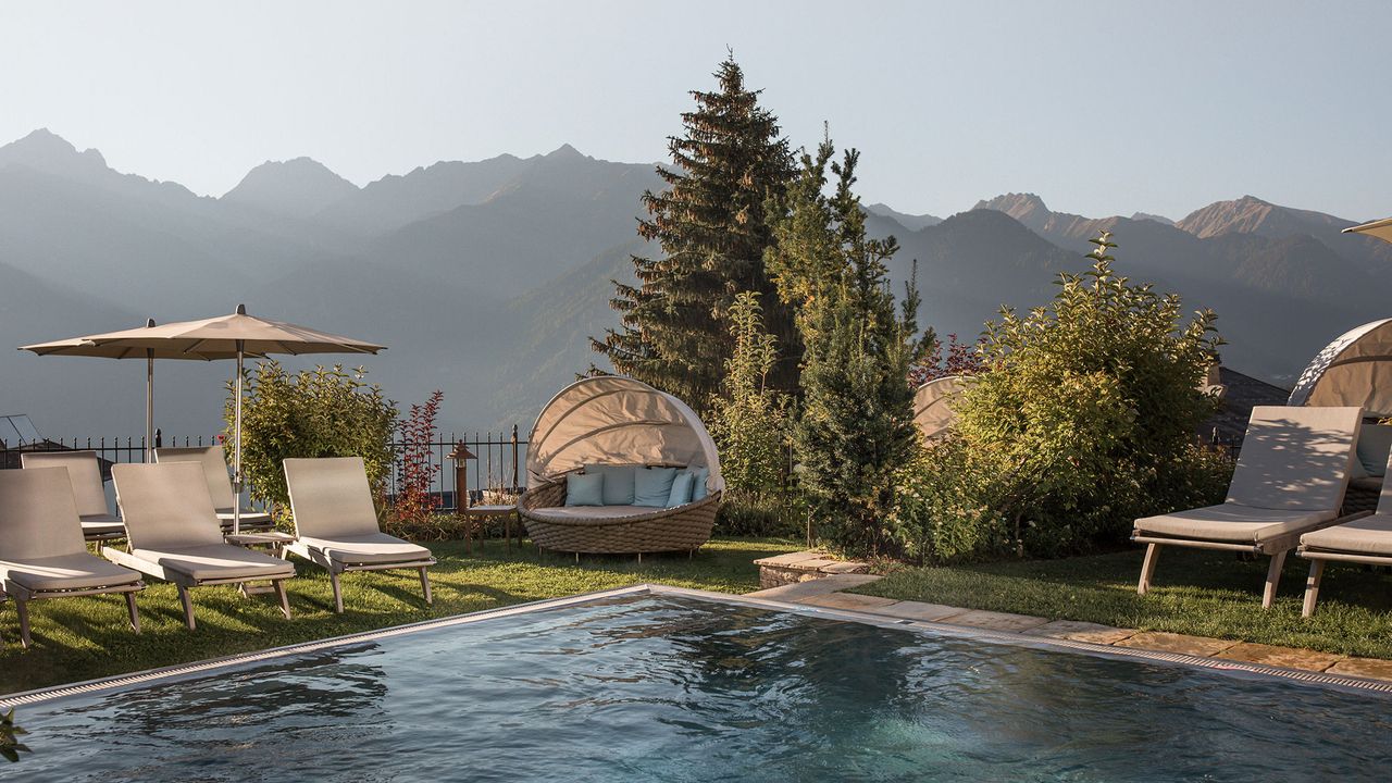 The pool at Schlosshotel Fiss with mountain backdrop