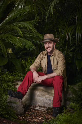 Seann Walsh sitting down in his jungle gear for I'm A Celebrity