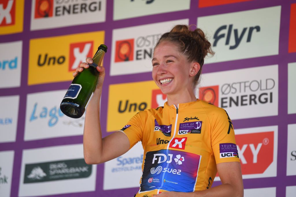 HALDEN NORWAY AUGUST 14 Cecilie Uttrup Ludwig of Denmark and Team FDJ Nouvelle Aquitaine Futuroscope Yellow Leader Jersey celebrates with champagne at podium as final overall winner during the 8th Tour of Scandinavia 2022 Battle Of The North Stage 6 a 1543km stage from Lillestrm to Halden UCIWWT tourofscandinavia TOSC22 on August 14 2022 in Halden Norway Photo by Luc ClaessenGetty Images