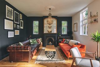 dark blue living room with fireplace and orange sofa