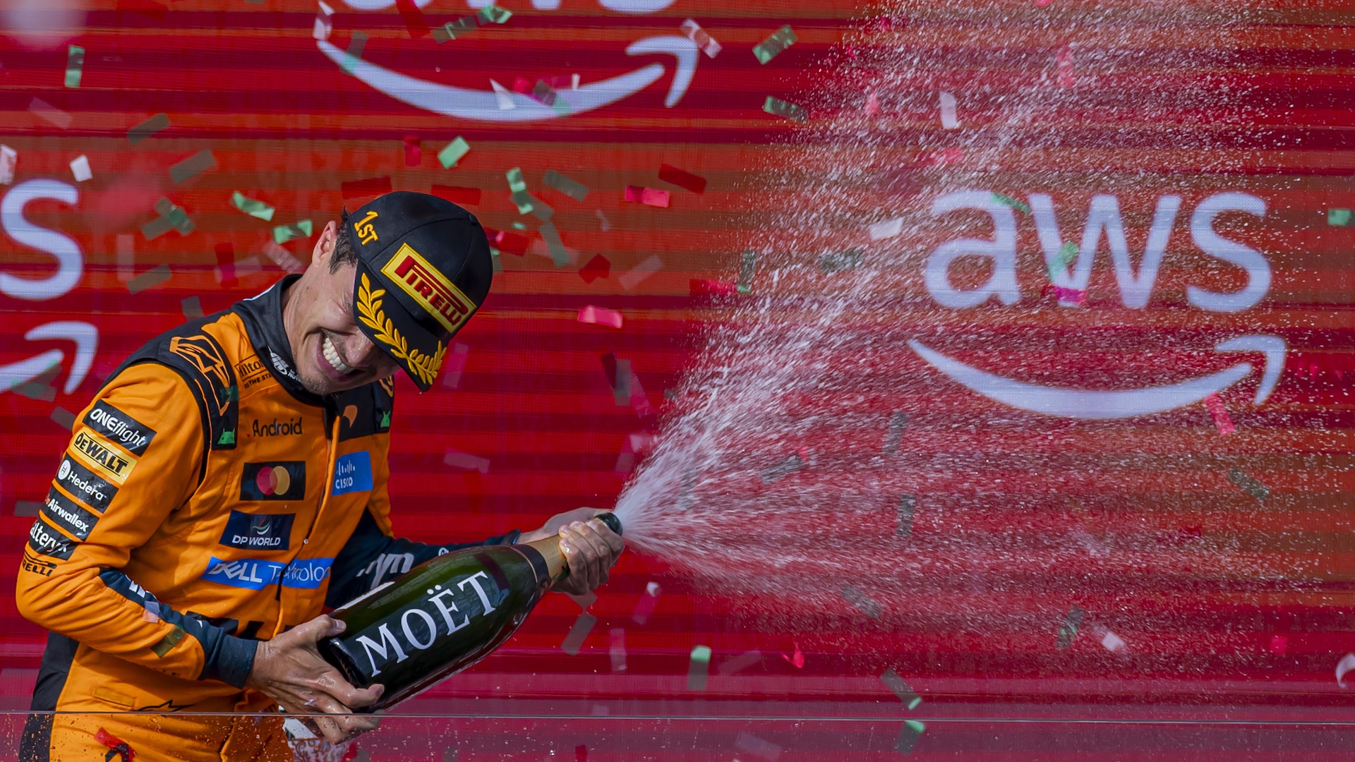 Lando Norris splashes champagne on the podium at the Formula 1 AWS Hungarian Grand Prix in Mogyorod, Hungary, on July 26, 2026. (Photo by Robert Szaniszlo/NurPhoto via Getty Images)