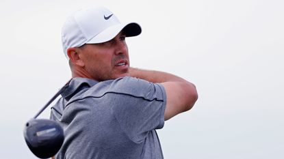 Brooks Koepka holds his finish on a drive