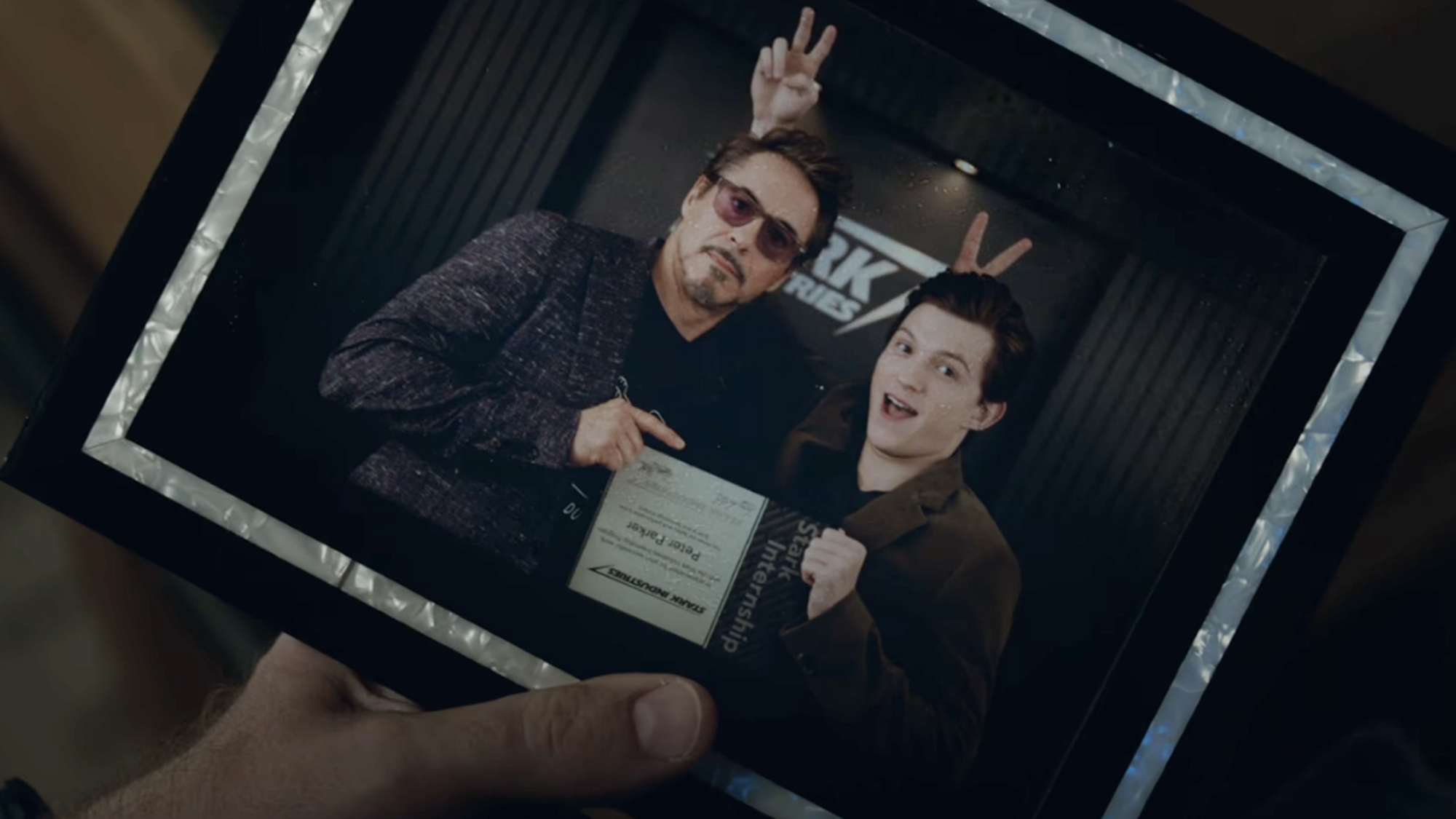 Tony Stark (Downey Jr) holds a picture of him and Peter, before the snap, in Avengers: Endgame.