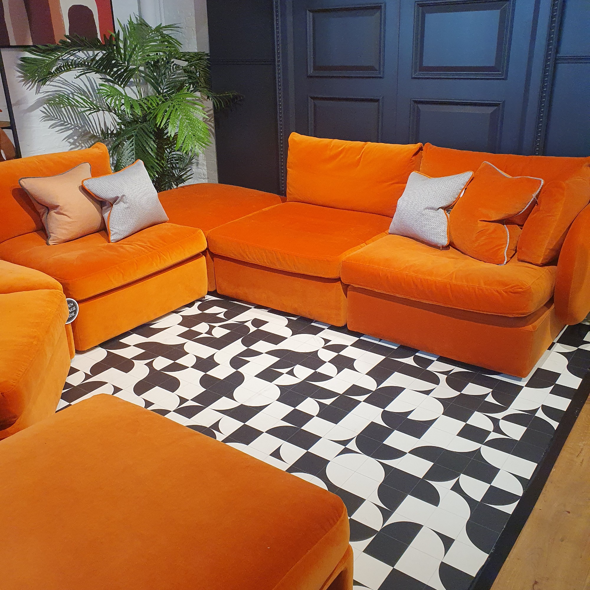 An orange U-shaped Ren modular sofa from Sofa.com at the brand's London showroom
