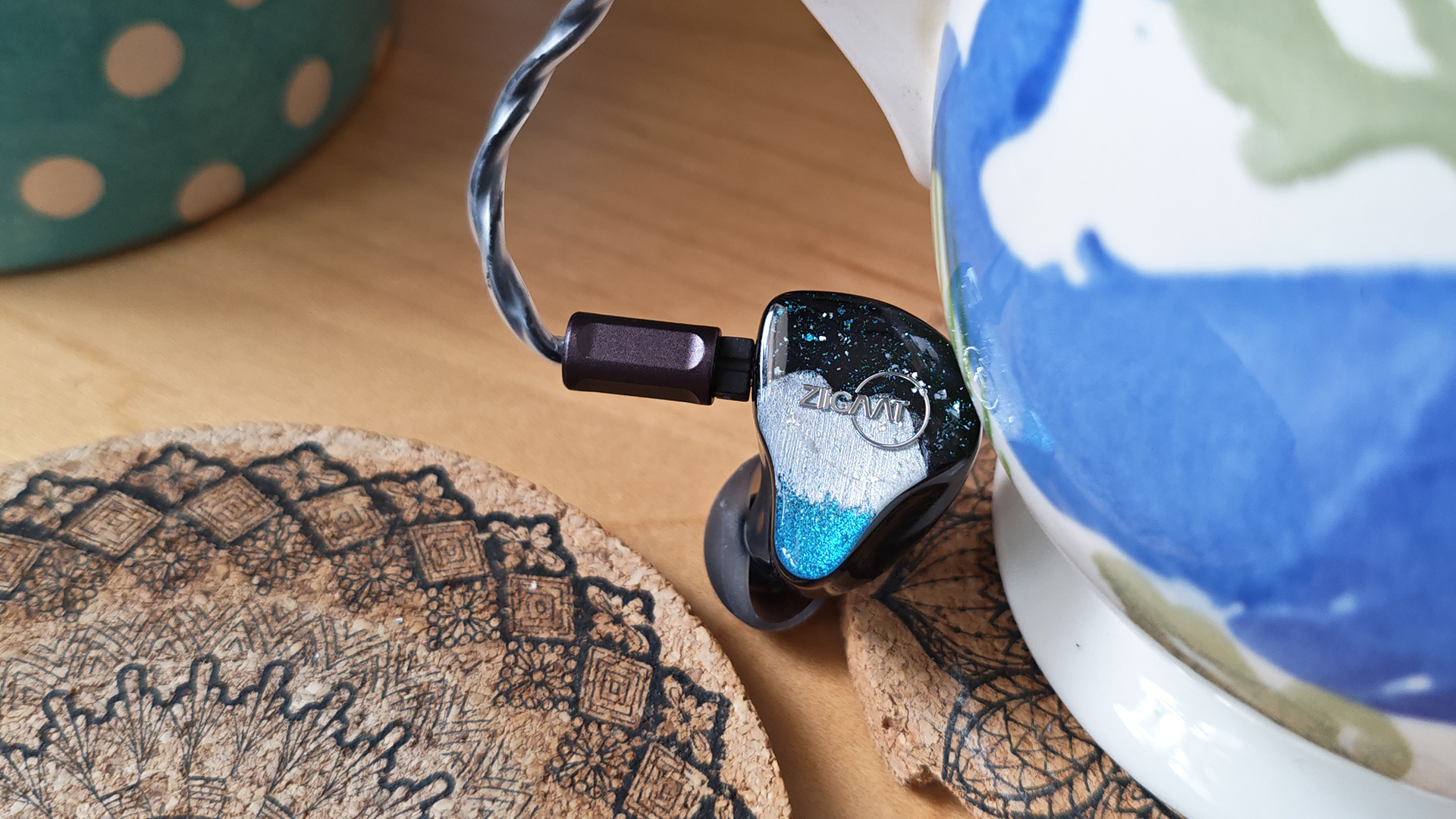 One of the two Ziigaat Horizon IEMs on a desktop.