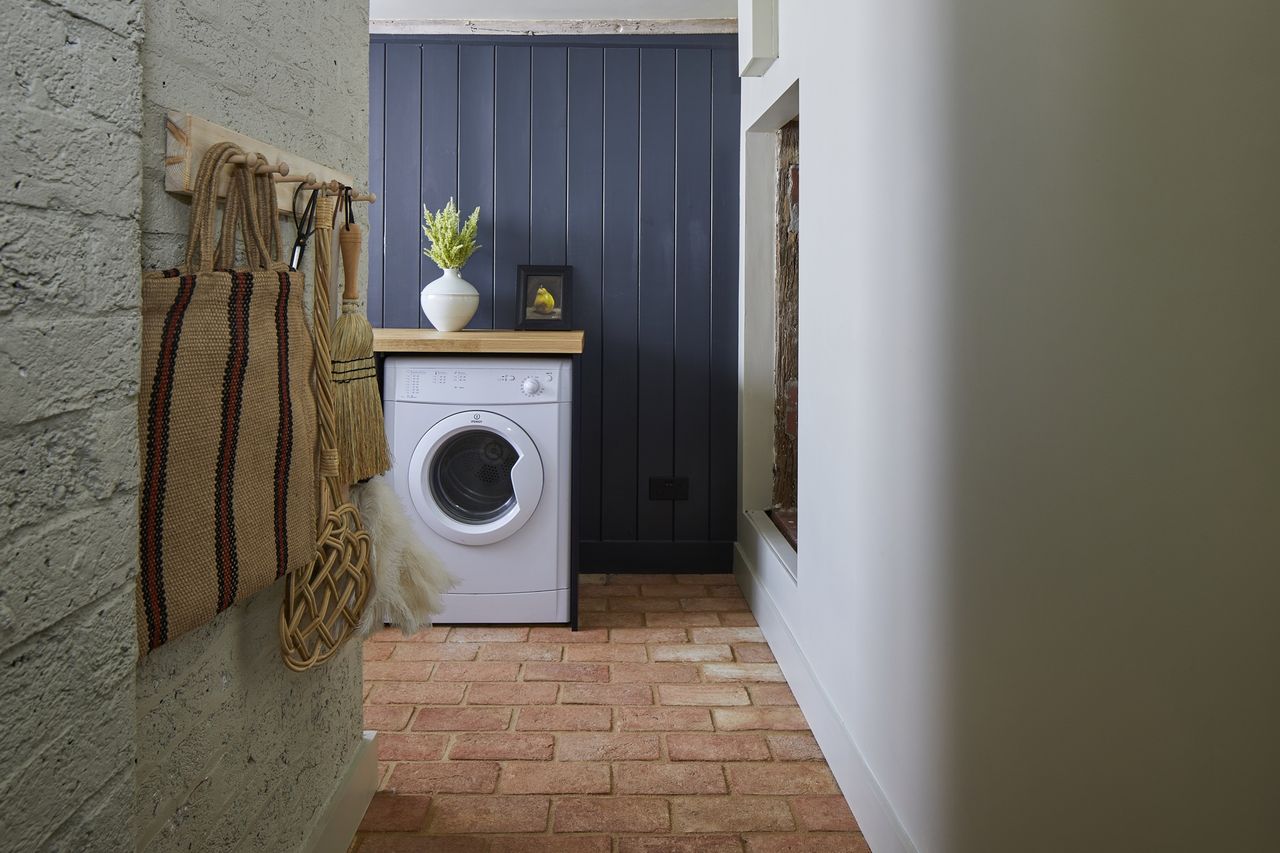 small laundry room ideas wall hooks, blue wood clad walls and terracotta floor tiles by Ca&#039;Pietra