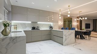 Luxury large modern white marble kitchen united with dining room and living room