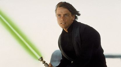 Luke Skywalker grimacing as he holds his green lightsaber in Star Wars Episode VI: Return of the Jedi