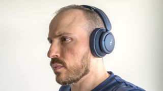 Wearing Anker Soundcore Q35 headphones.