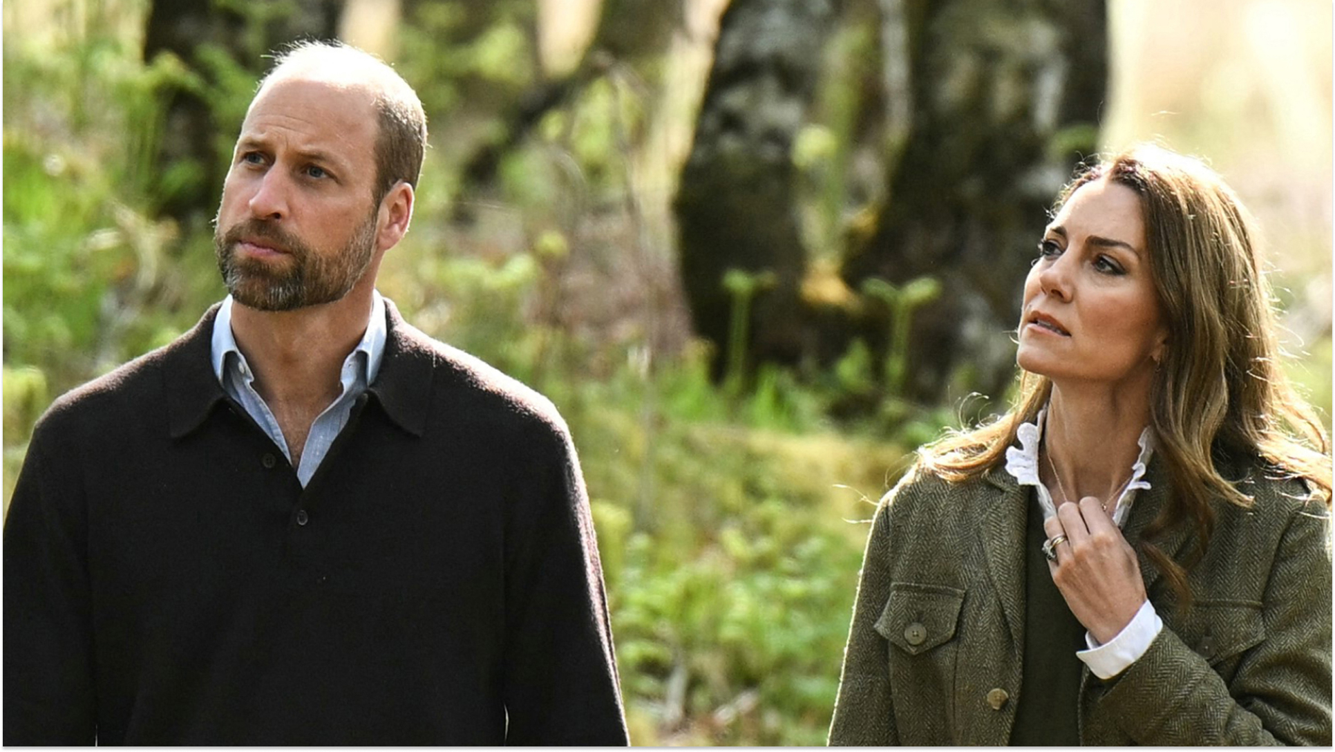 Prince William wears a V-neck sweater with a blue shirt underneath and Kate Middleton wears a green jacket