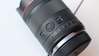 Close up of the buttons on a Canon RF 14mm f/1.4L VCM lens on a windowsill
