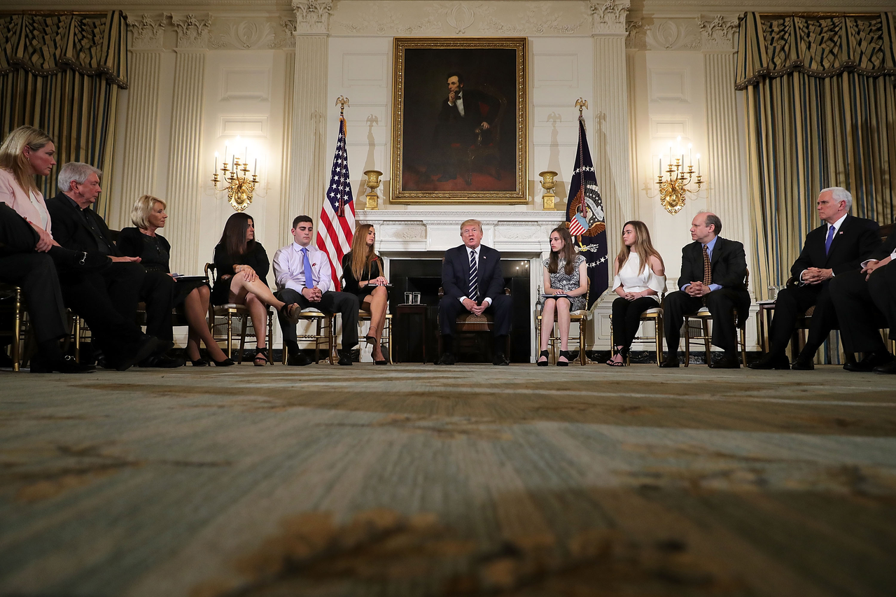 President Donald Trump listens to survivors of school shootings. 