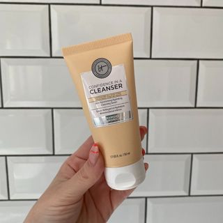 Original image showing hand holding the IT Cosmetics Confidence in a Cleanser