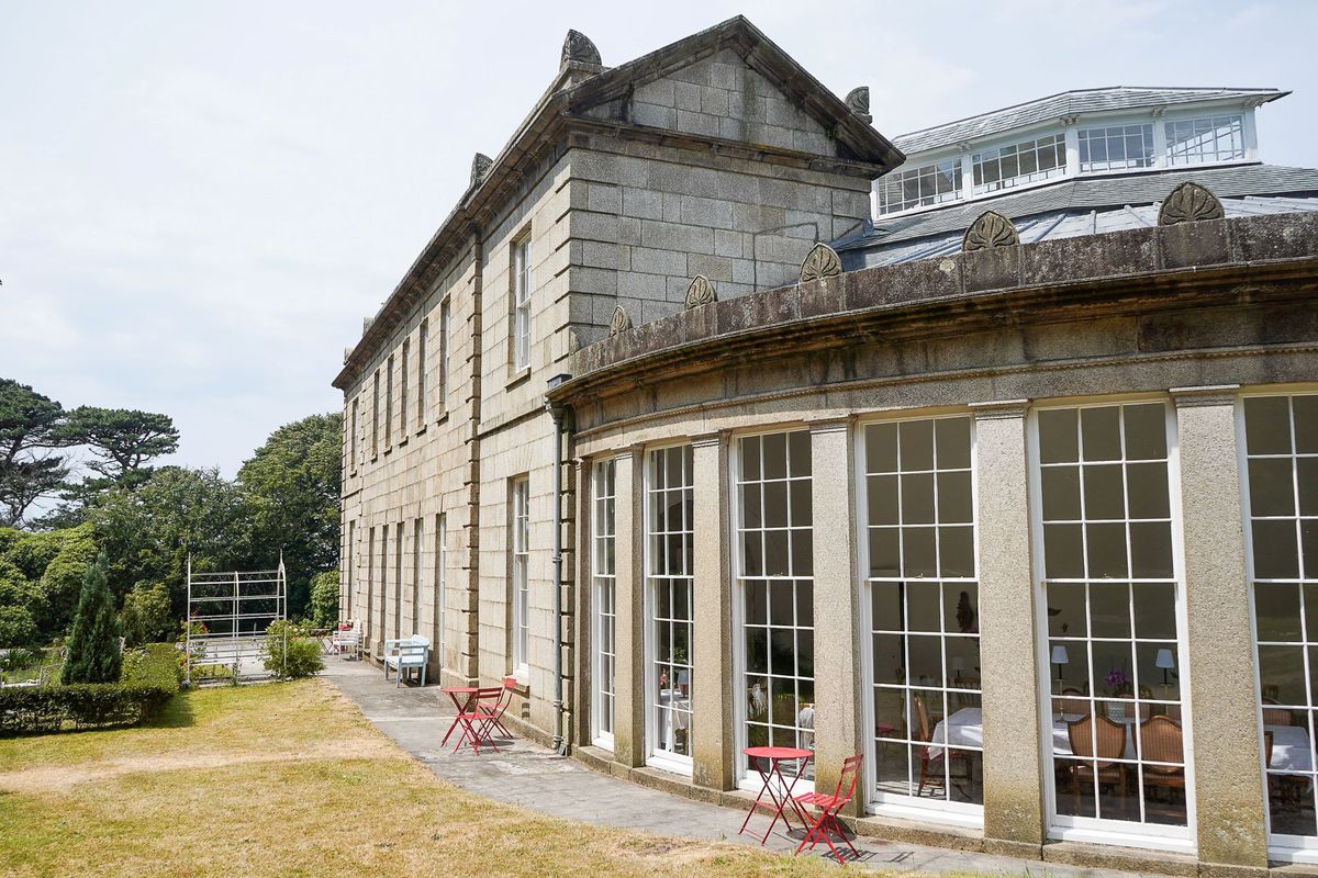 An exterior view of the home with stone walls and large windows