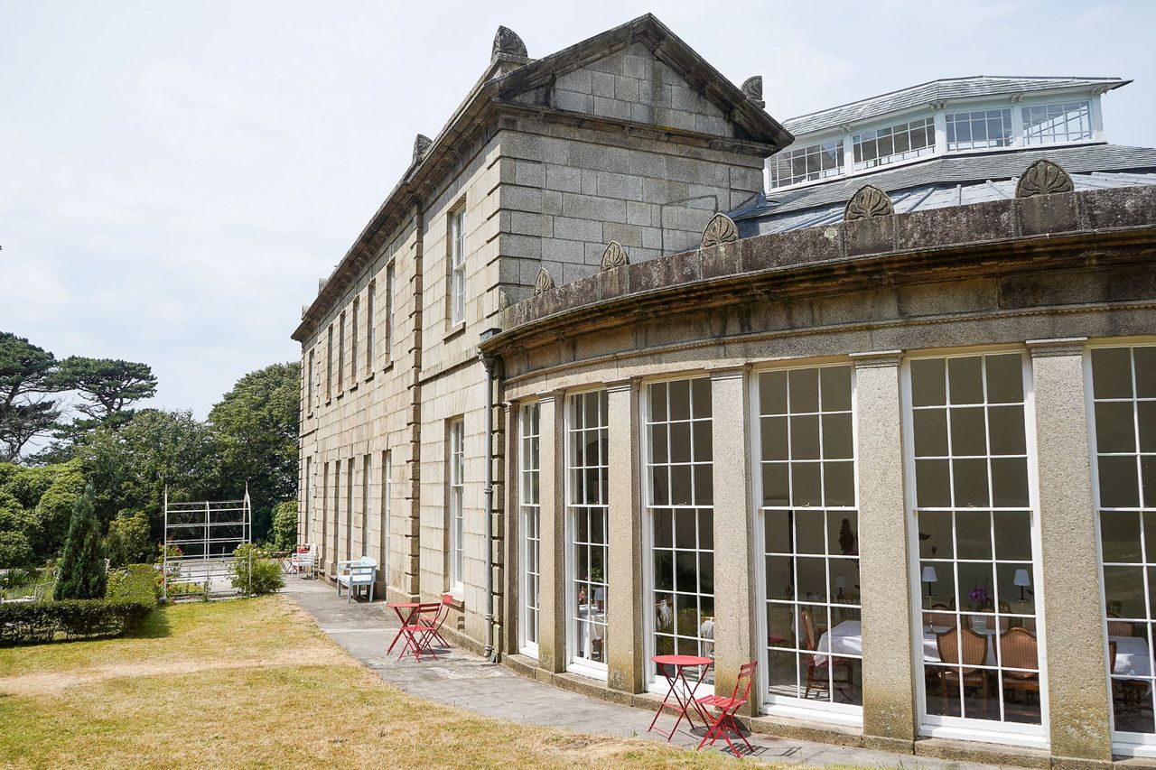 An exterior view of the home with stone walls and large windows