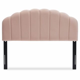 A soft pink velvet tufted headboard that's a part of Drew Barrymore's furniture collection.