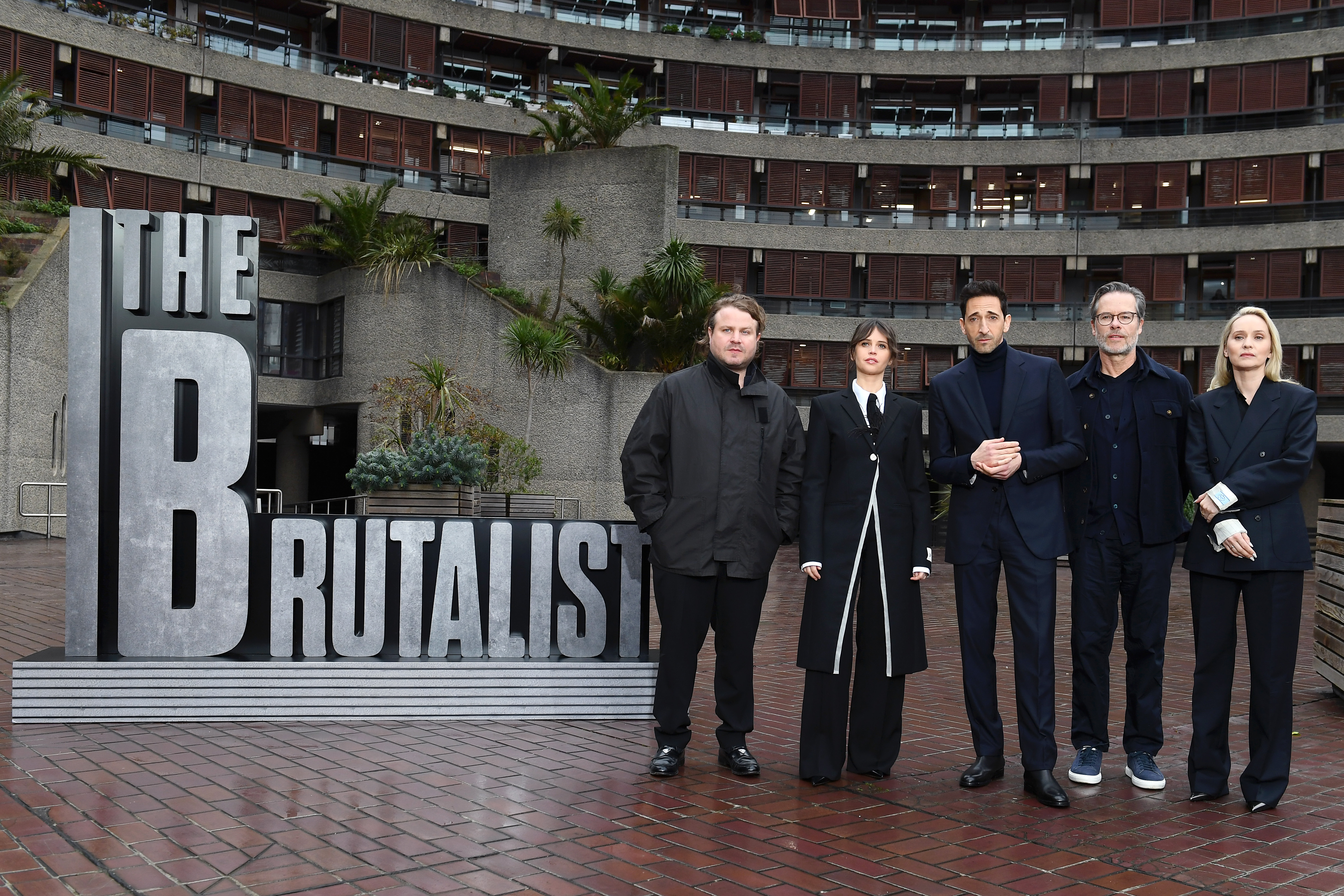 LONDON, ENGLAND - JANUARY 15: Brady Corbet, Felicity Jones, Adrien Brody, Guy Pearce and Mona Fastvold attend 