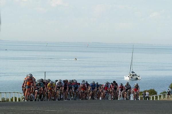 The men's peloton in Geelong's Eastern Gardens with Corio Bay in the background.