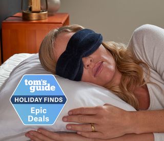 A lady sleeps on her side while wearing a Tempur-Pedic eye mask