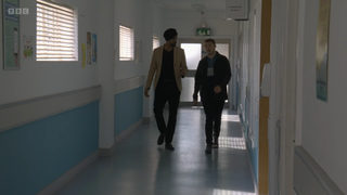 Kheerat and Ben walking through a hospital