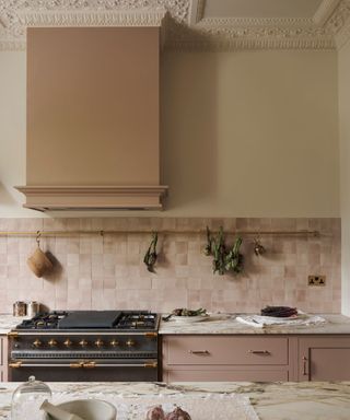 Pink and white kitchen with pale pink zellige tile backsplash