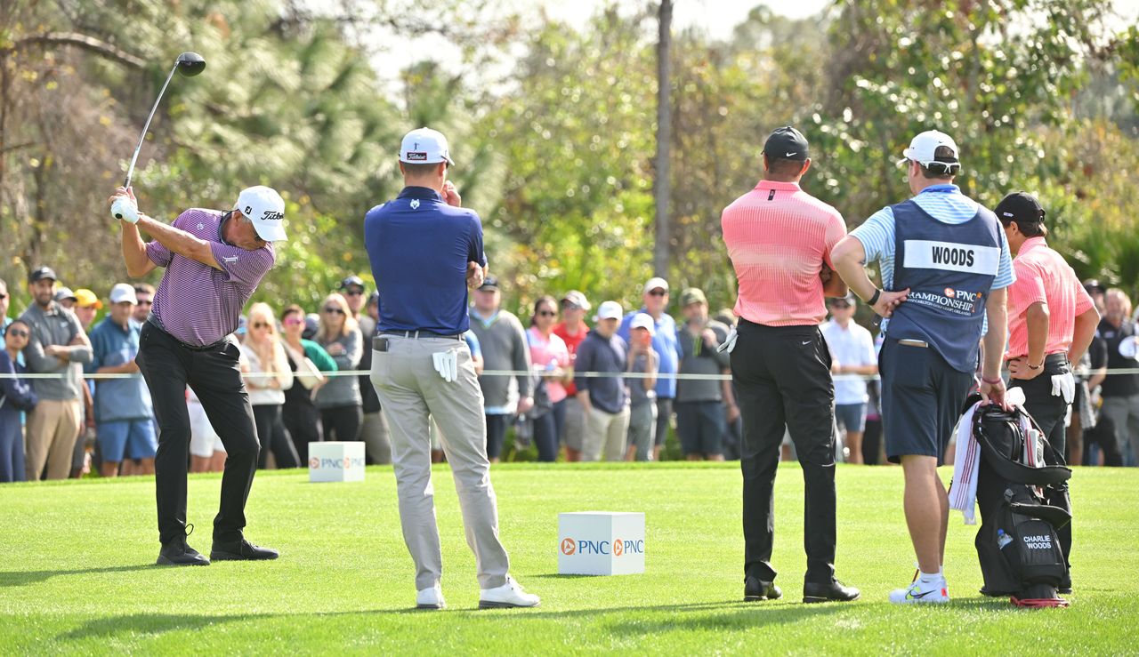 Mike Thomas tees off while Justin, Tiger and Charlie watch on