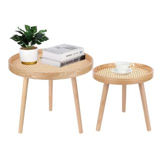 Two round woven wooden tables with decor on it
