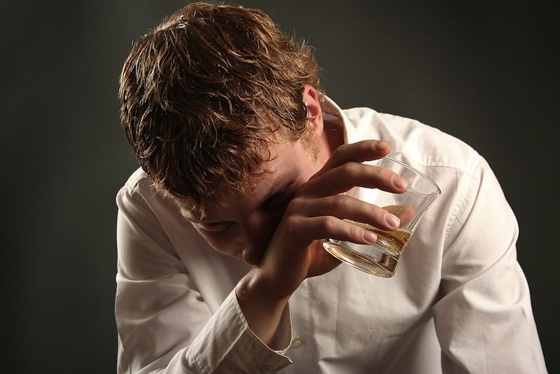 A young man drinking whisky