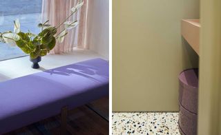A purple ottoman with flowers next to a window to the left. To the right, we see olive green walls with tiny stone flooring.
