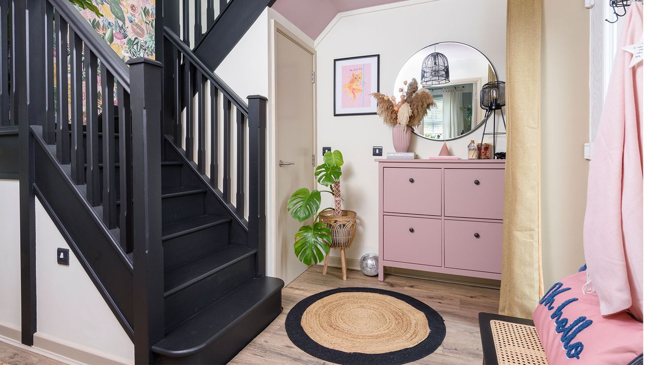 Hallway with black staircase and shoe storage