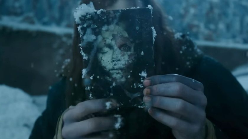 Jacob Elordi looking through a photo in Frankenstein.