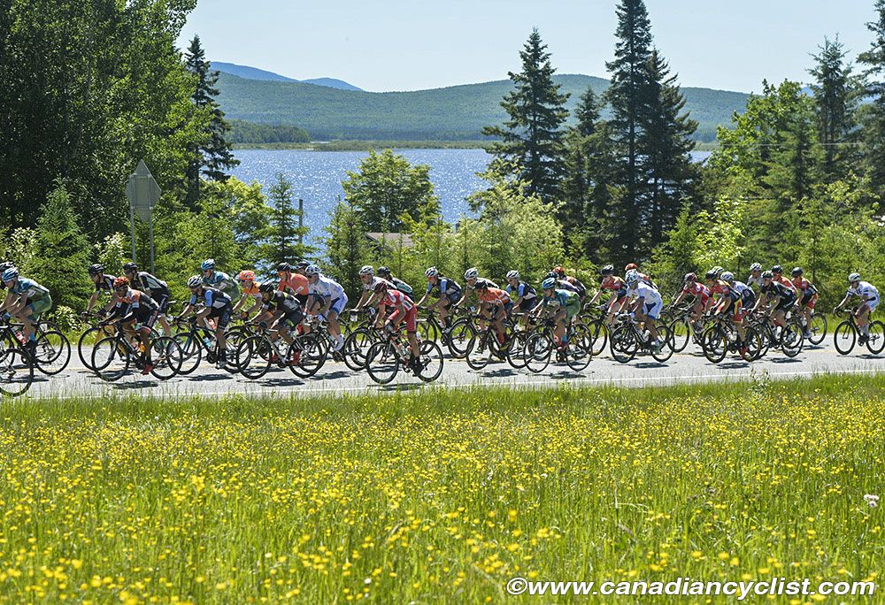Peloton passes by Lac Megantic during the stage