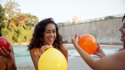 Female having fun with party balloon