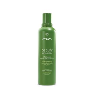 A 120ml green shampoo bottle of Aveda Be Curly Advanced Shampoo.