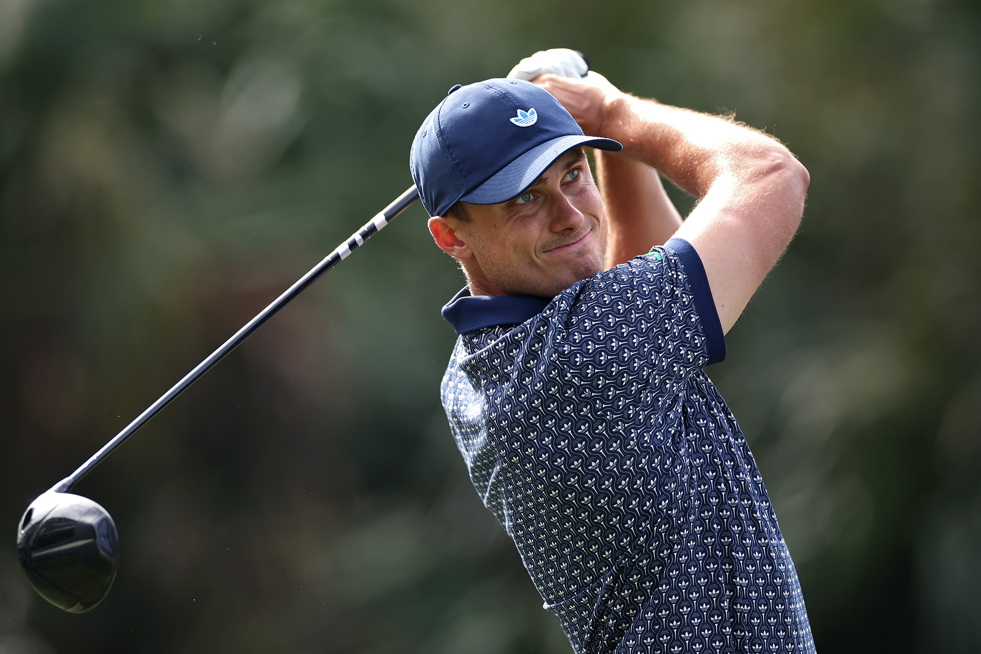 Ludvig Aberg in the finish position with driver watching his ball flight