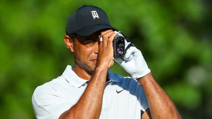 Tiger Woods with a rangefinder before the 2022 PGA Championship at Southern Hills