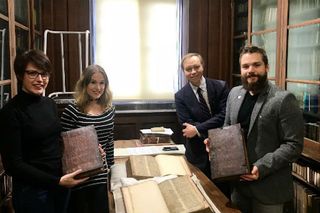 From left to right: Leah Tether, Laura Chuhan Campbell, Michael Richardson and Benjamin Pohl show books in Bristol Central Library's Rare Books Room.