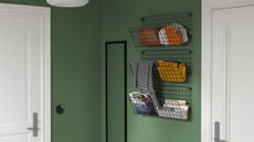 three metal wall shelving units hung in a row