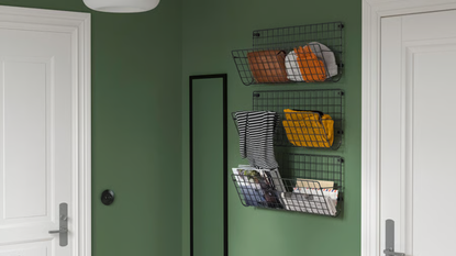 three metal wall shelving units hung in a row