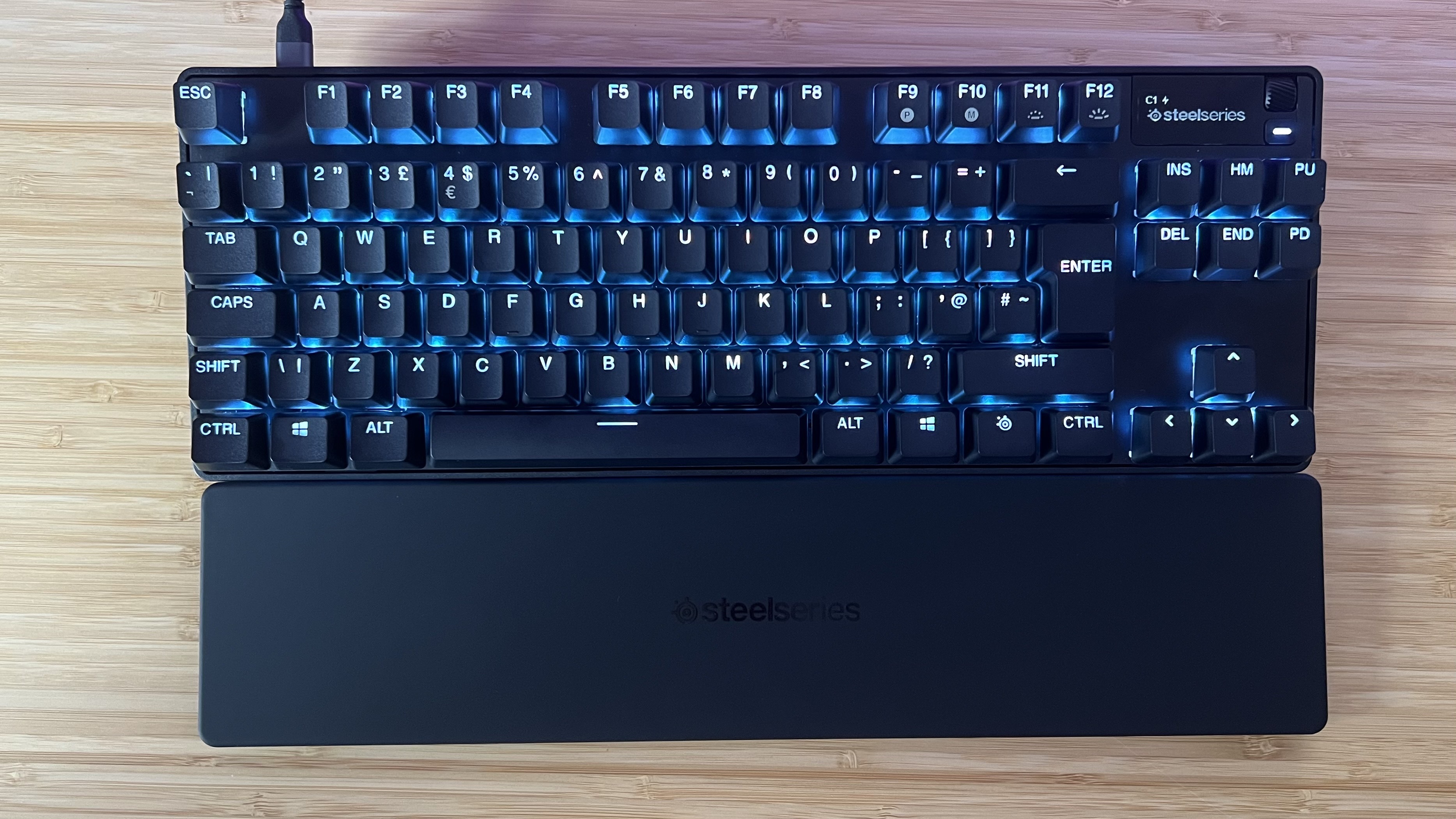 SteelSeries Apex Pro TKL Gen 3 keyboard on a wooden desk