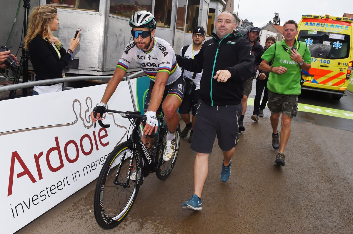 Peter Sagan is escorted to the podium after his stage win