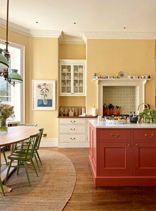Kitchen with yellow walls and red painted island
