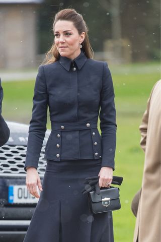 Kate Middleton carries a black handbag and coat as she visits the Defence Medical Rehabilitation Centre Stanford Hall on February 11, 2020 in Loughborough, United Kingdom.