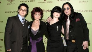 The Osbournes dressed smartly and smiling on a red carpet