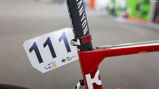 The Katusha-Alpecin mechanics repurposed a water bottle into a number plate holder