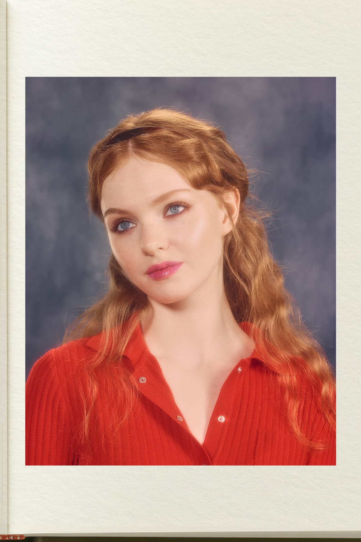 A model wearing a red top, with bronzed eyes and pink lips
