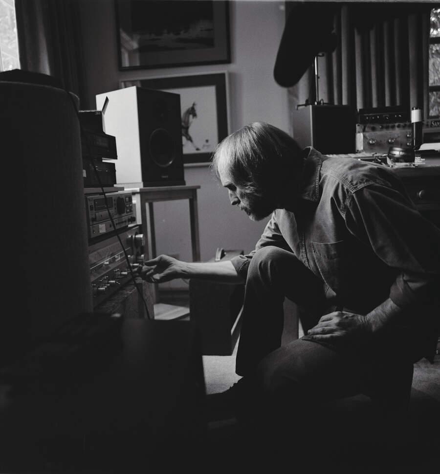 Tom Petty playing with the controls on a hifi amplifier